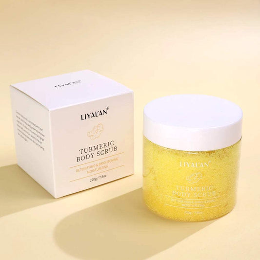 Turmeric sea salt body scrub for exfoliating, moisturizing, and brightening skin in a clear jar with white lid next to white box packaging